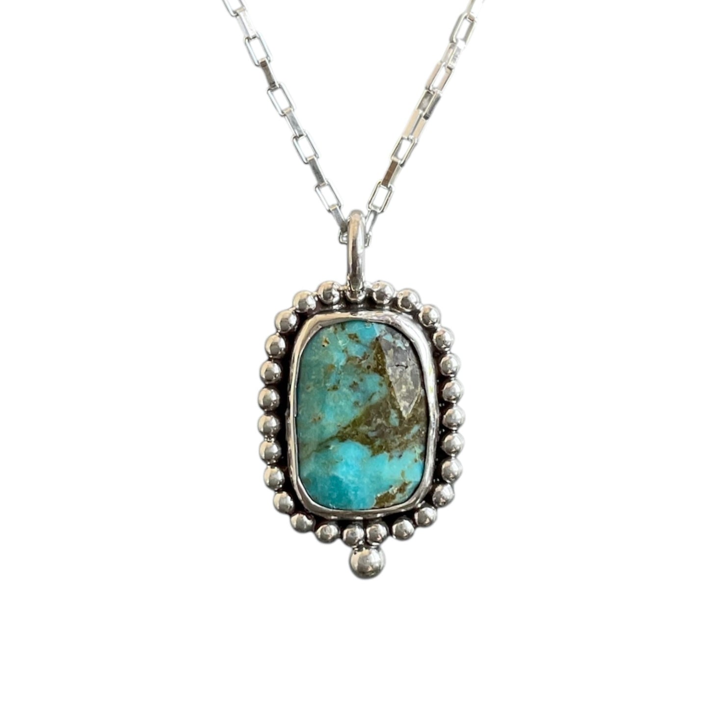 Turquoise pendant necklace on a white background