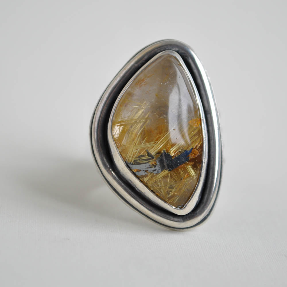 Chunky rutilated quartz with a ridged band and a wire border