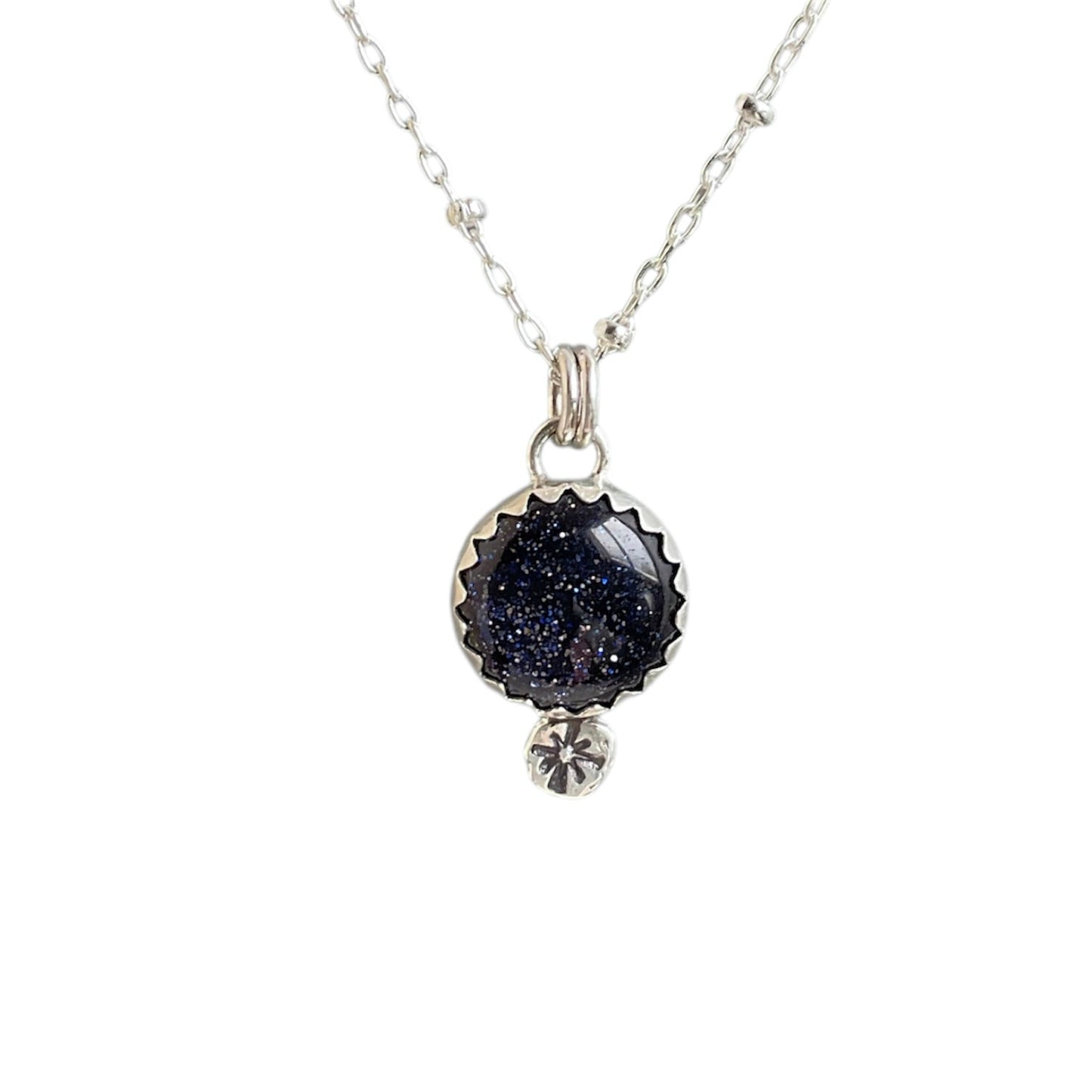 Goldstone gemstone bezel set and paired with a star drop embellishment underneath. Solid sterling silver setting and chain.