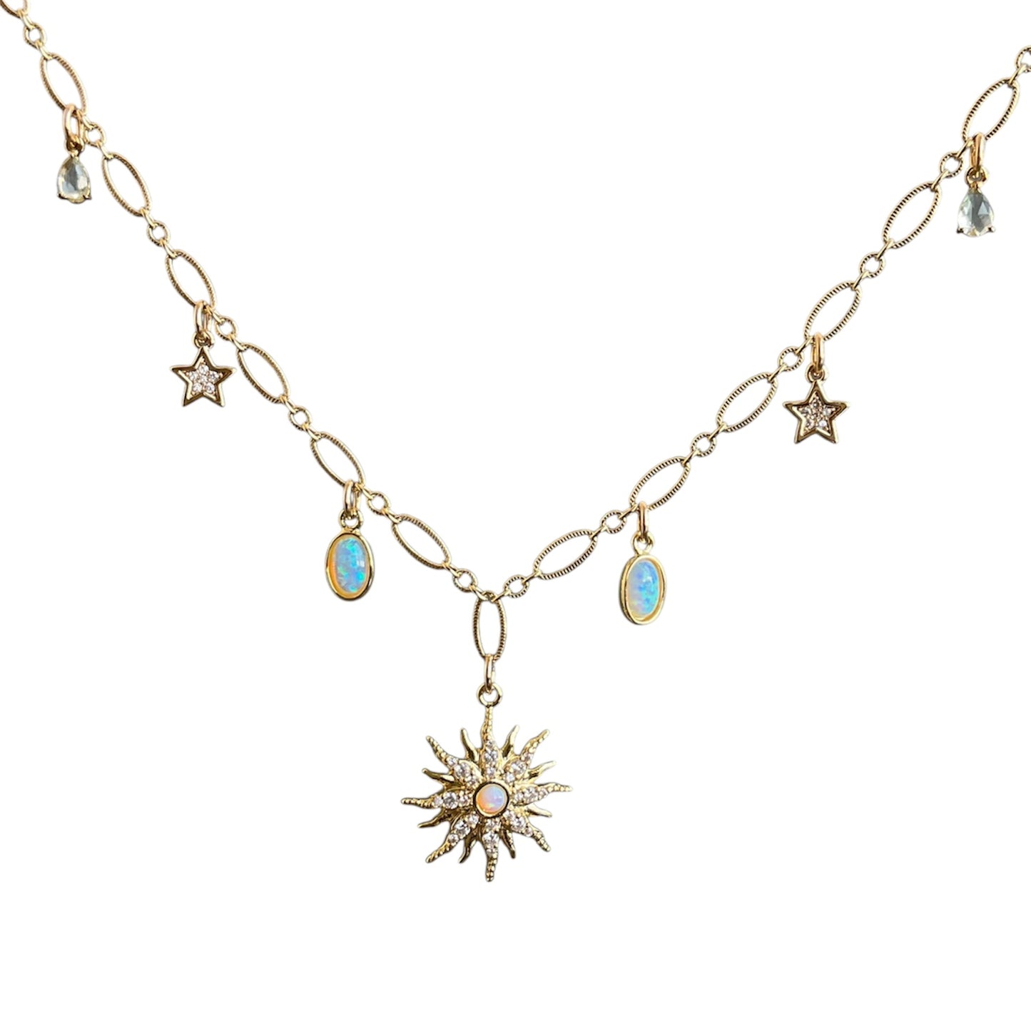 Gold necklace with star and sun-shaped pendants on a white background