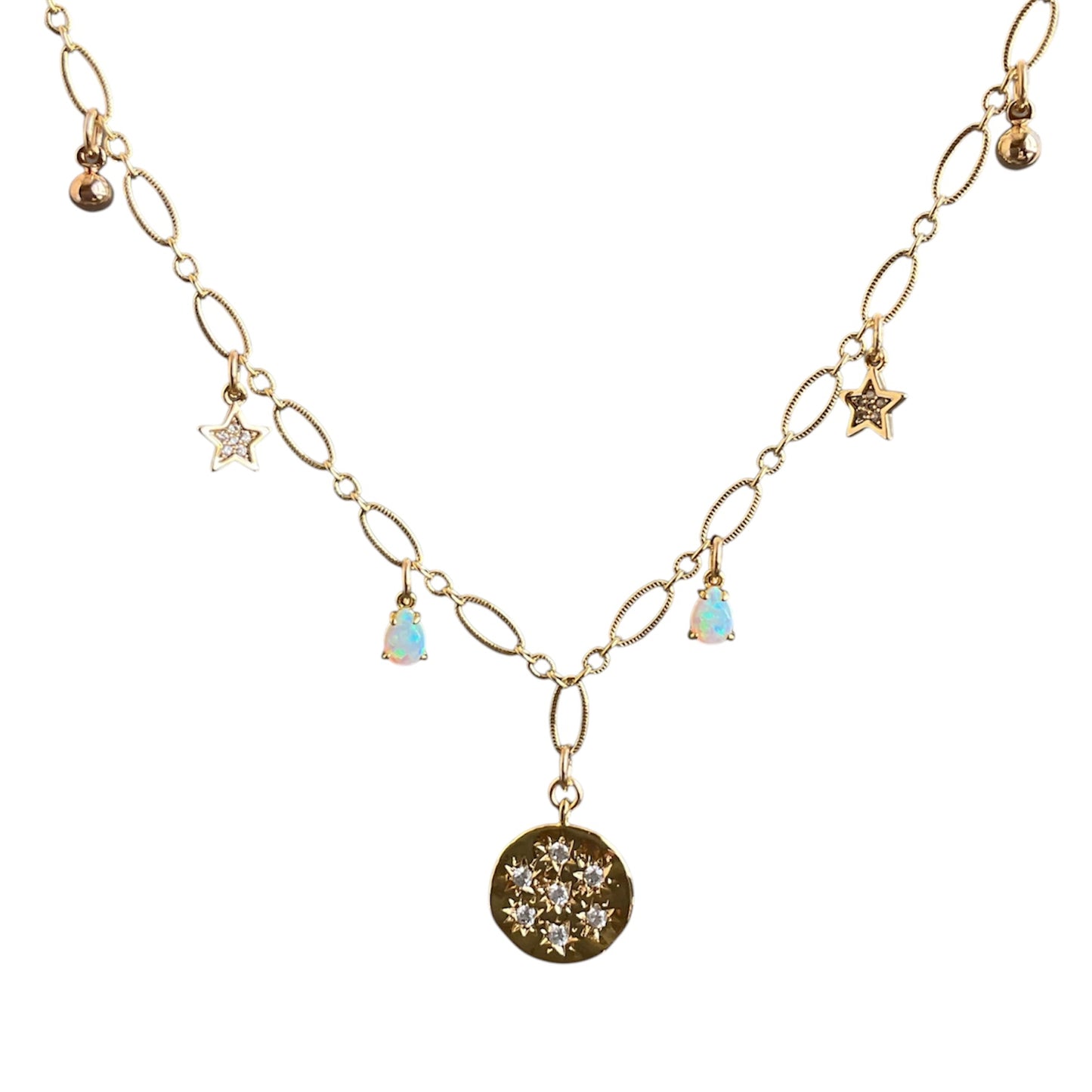 Gold necklace with star and opal pendant on a white background