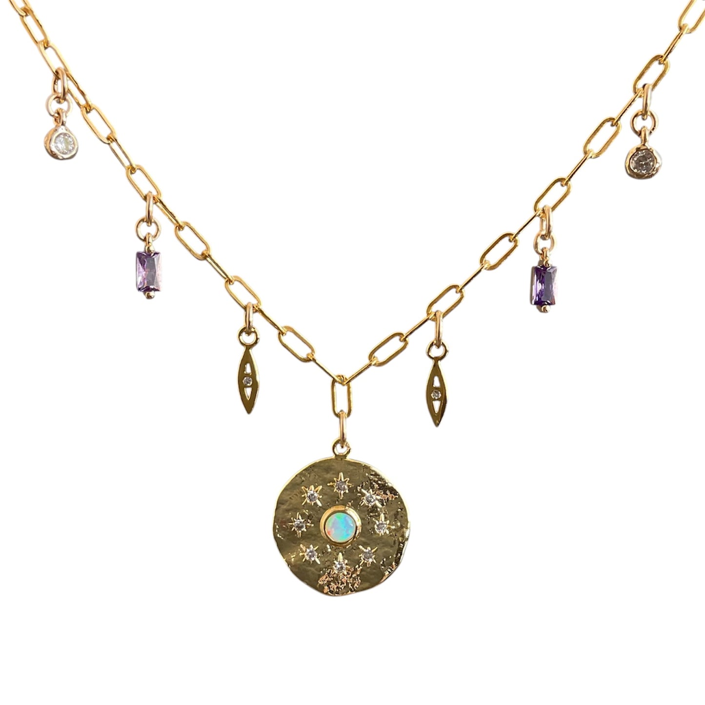 Gold necklace with various charms on a white background