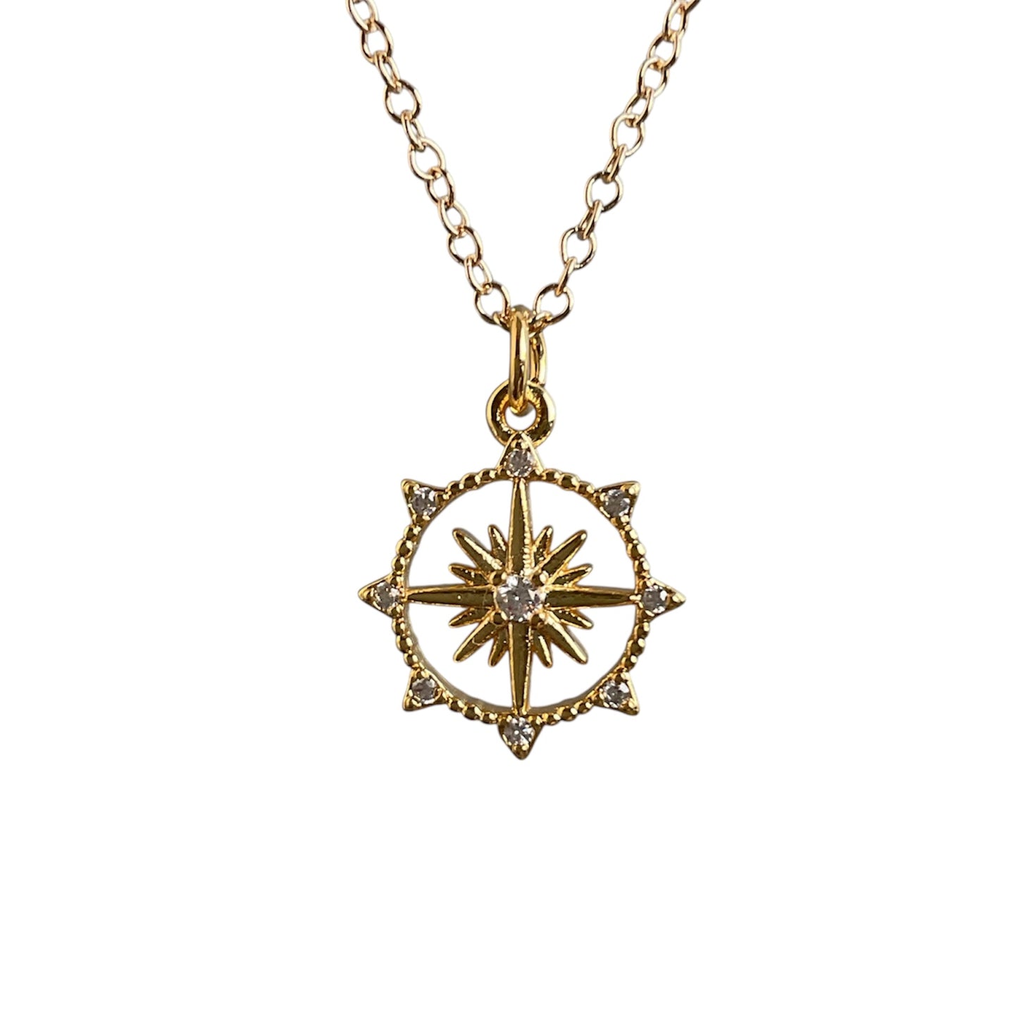 Gold necklace with a star-shaped pendant on a white background