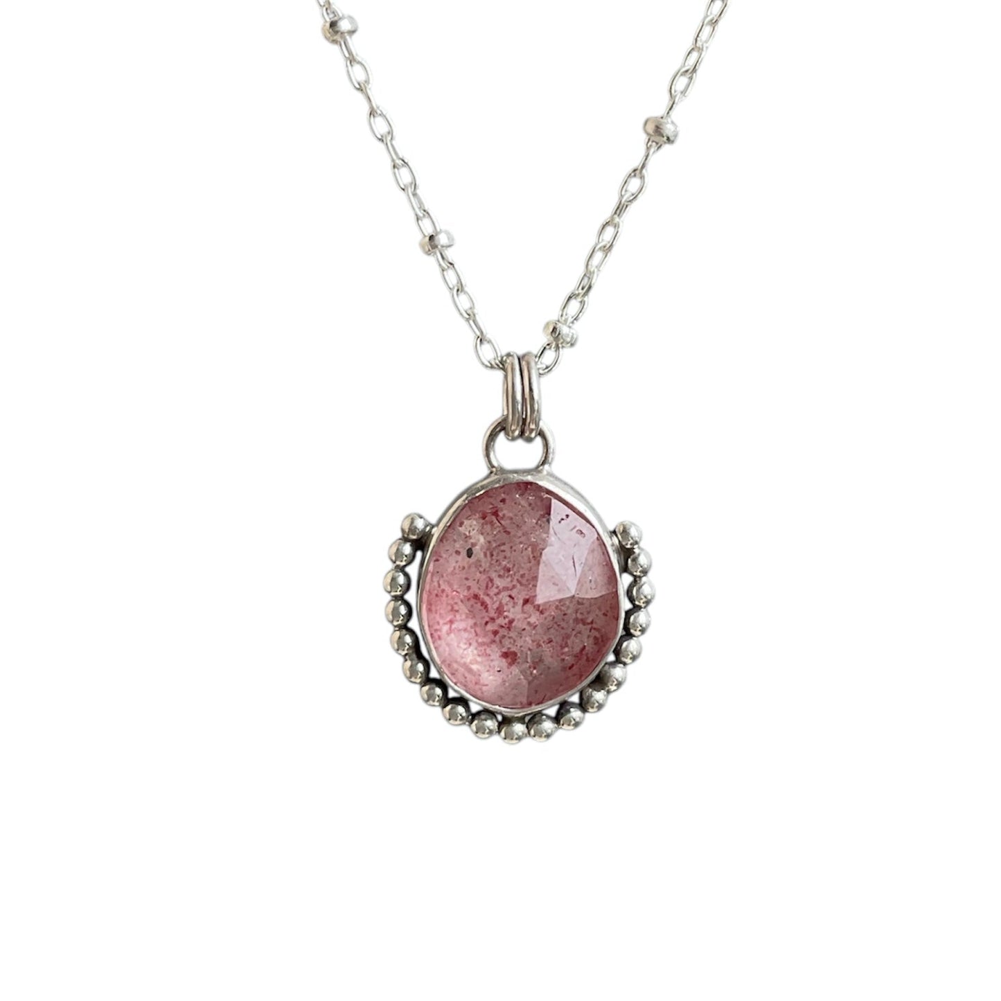 Faceted strawberry quartz gemstone bezel wrapped and frammed with a beaded border. Solid sterling silver setting and chain