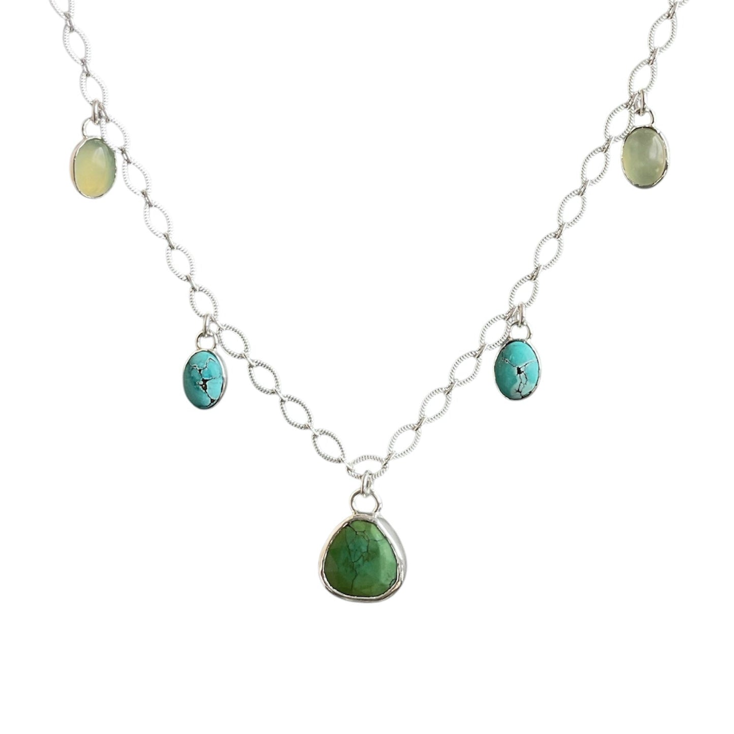 Green turquoise charm centered on a sterling silver oval lacey chain with blue turquoise and green jade gemstone charms.