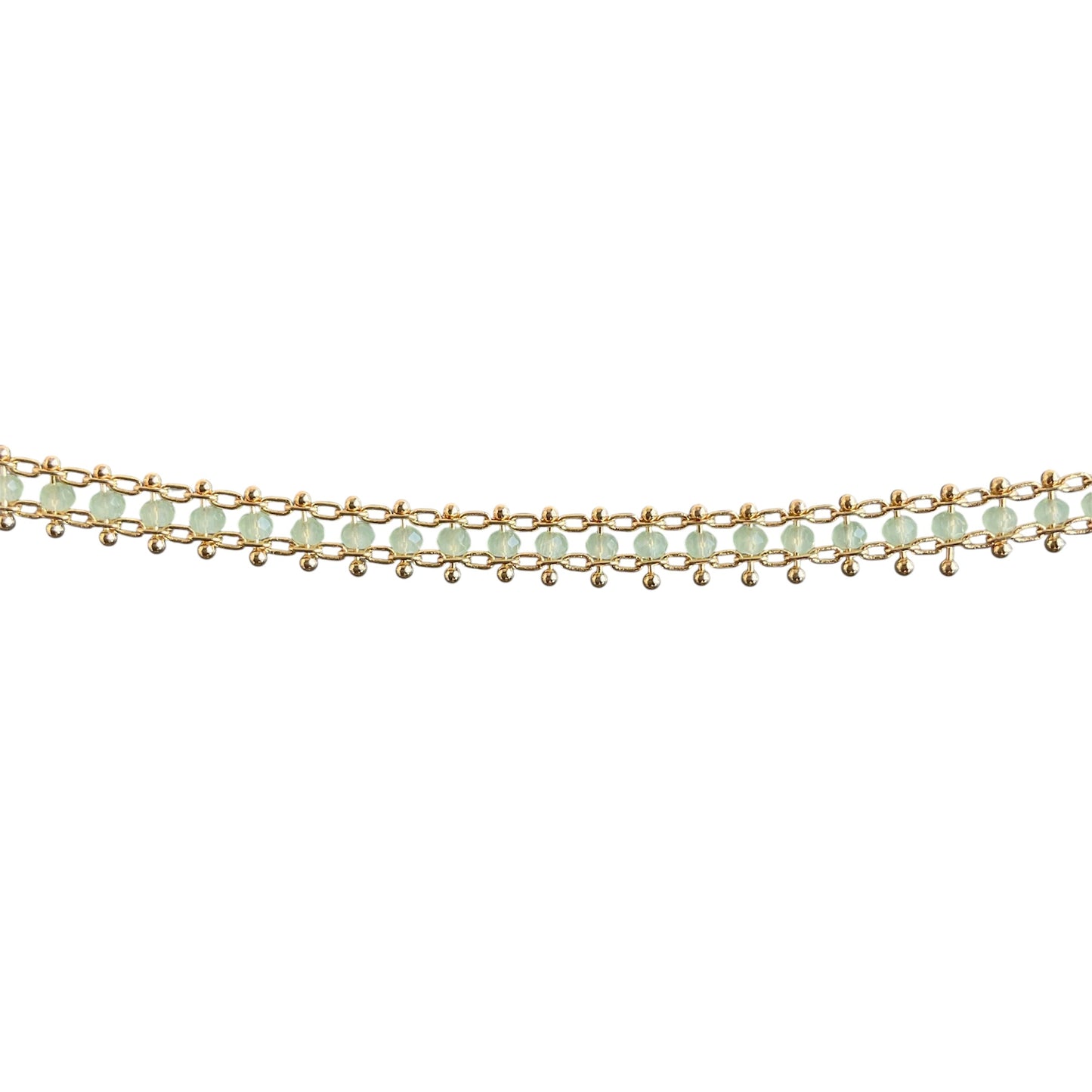 Gold bracelet with green beads on a white background