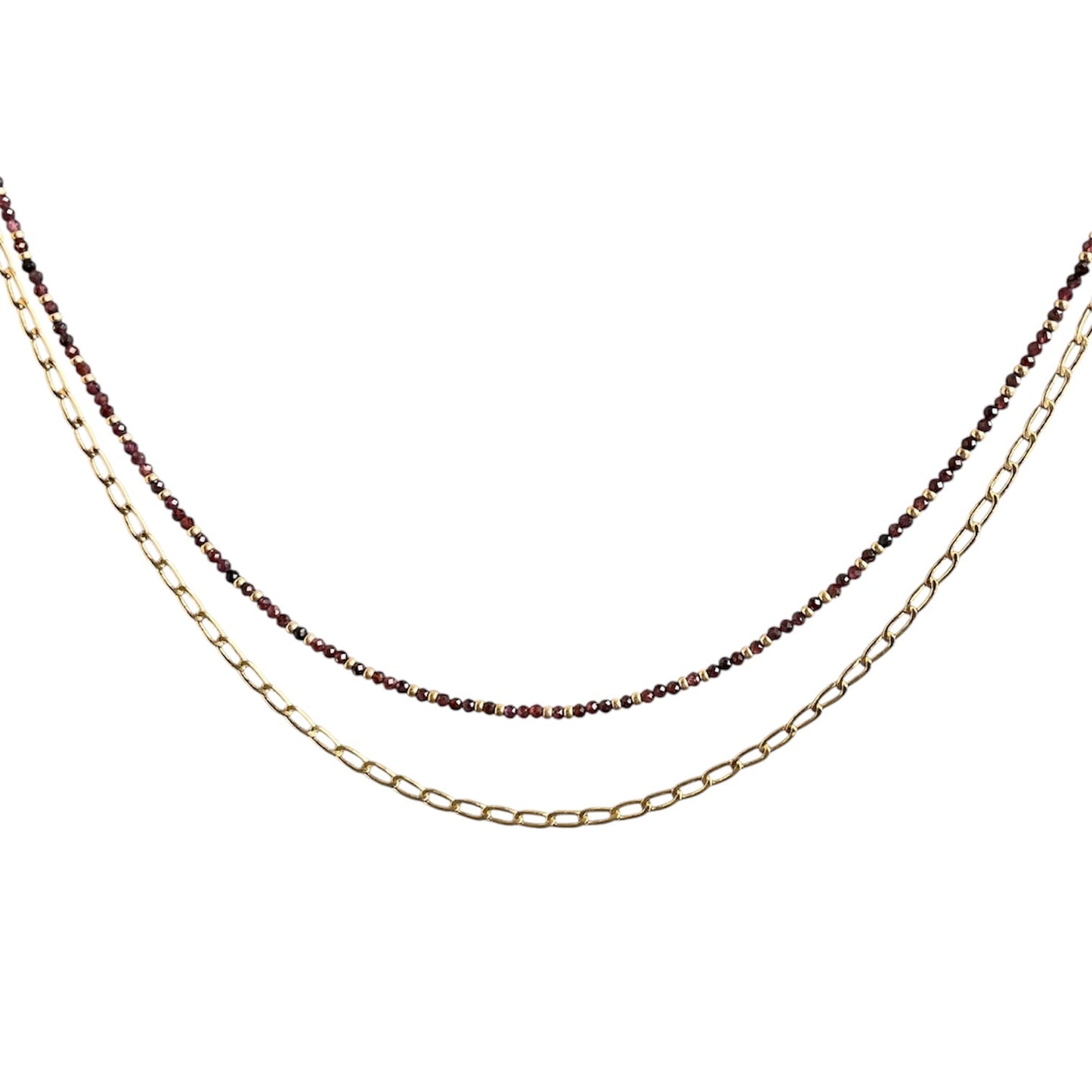 Layering necklace on a white background, one gold and one with small beads.
