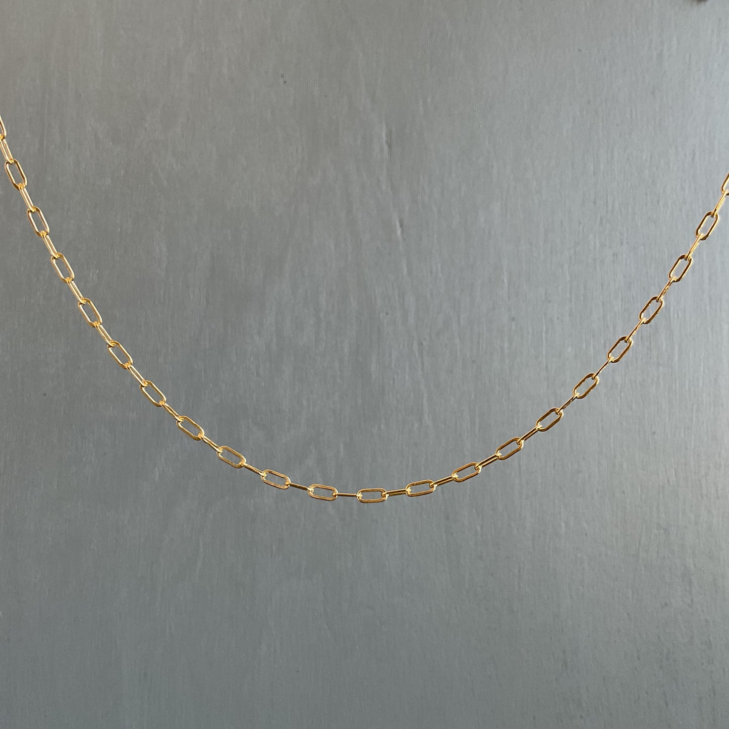 Gold chain on a gray background