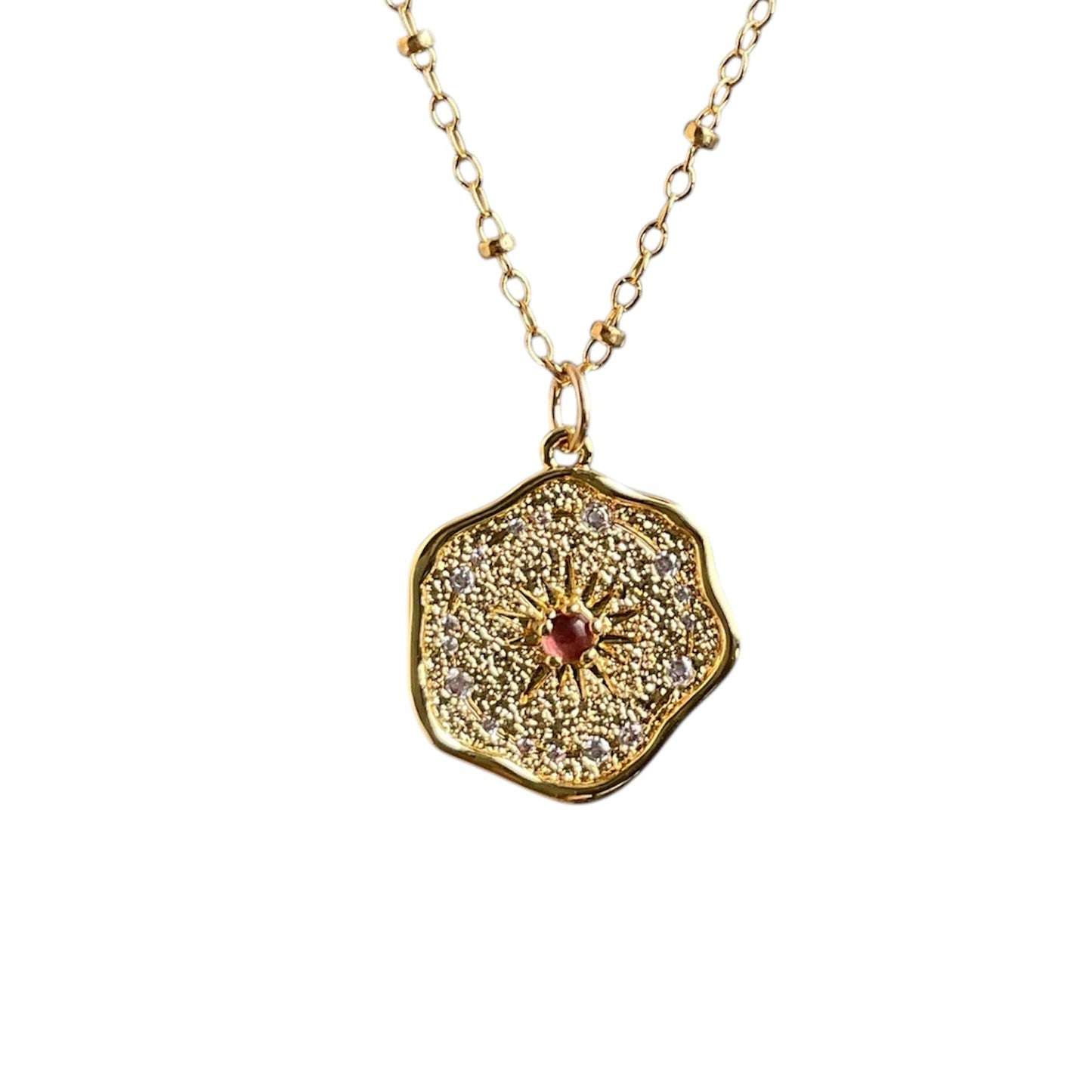 Whimsical wax seal pendant with pavé cubic zirconia's and a pink ruby center stone on a 14k gold-filled chain.