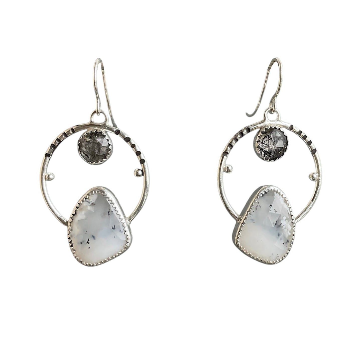 White and black gemstones in an open wire frame hoop earring design. All on sterling silver ear wires