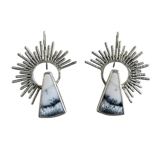 Pair of earrings with sunburst design and triangular stone on a white background