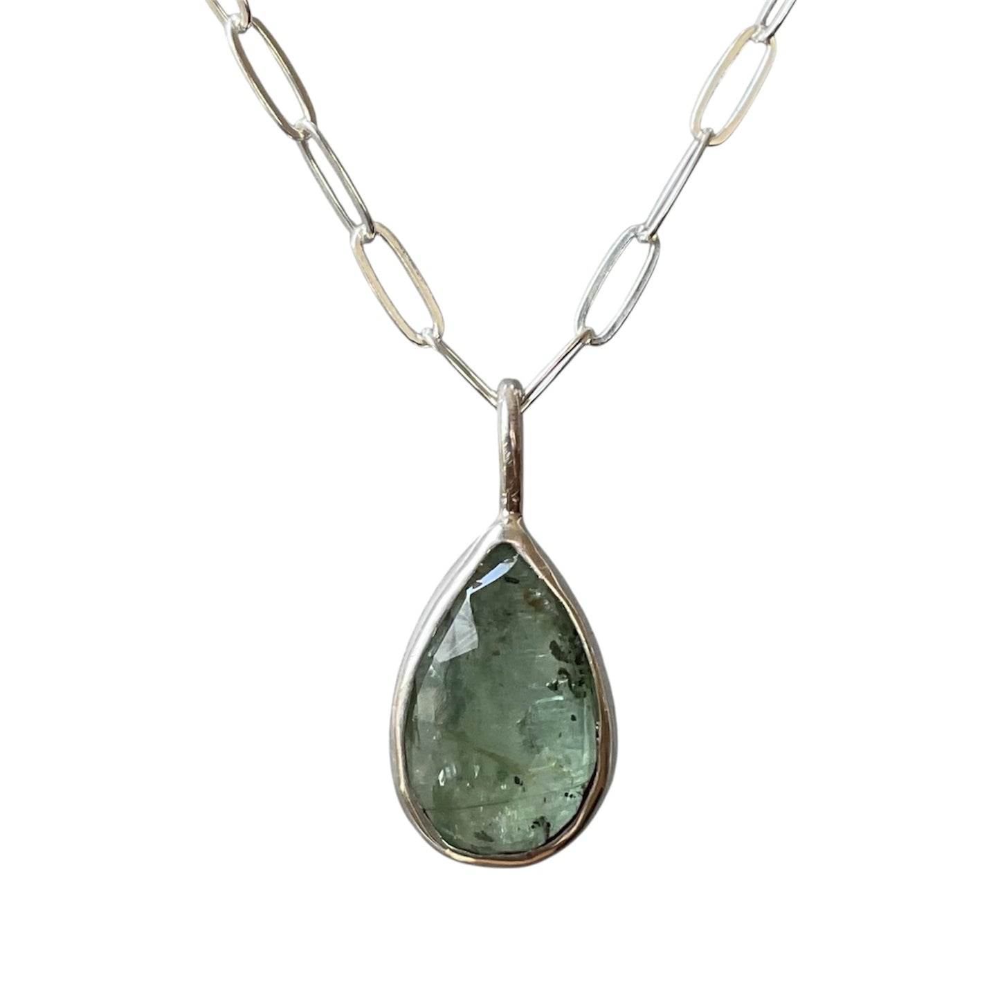 Teardrop-shaped pendant necklace with a silver chain on a white background