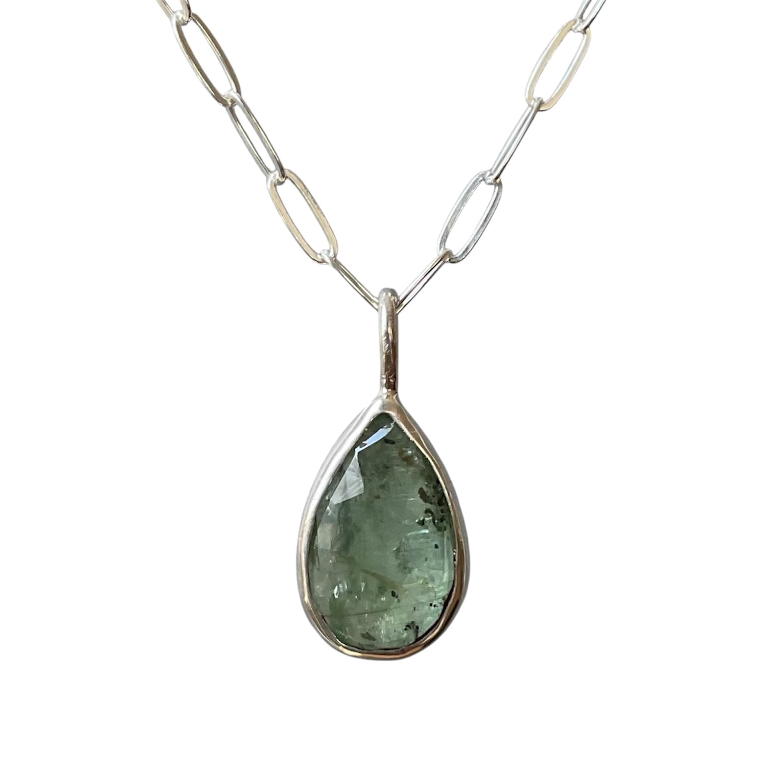 Teardrop-shaped pendant necklace with a silver chain on a white background