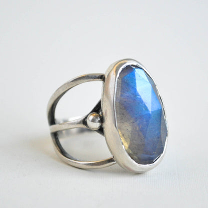Silver ring with a blue gemstone on a white background