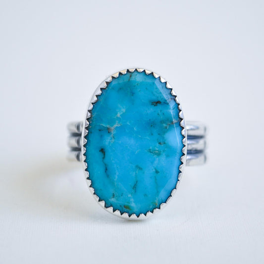 Turquoise ring with silver band on a white background