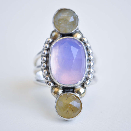 Ring with three oval stones on a white background