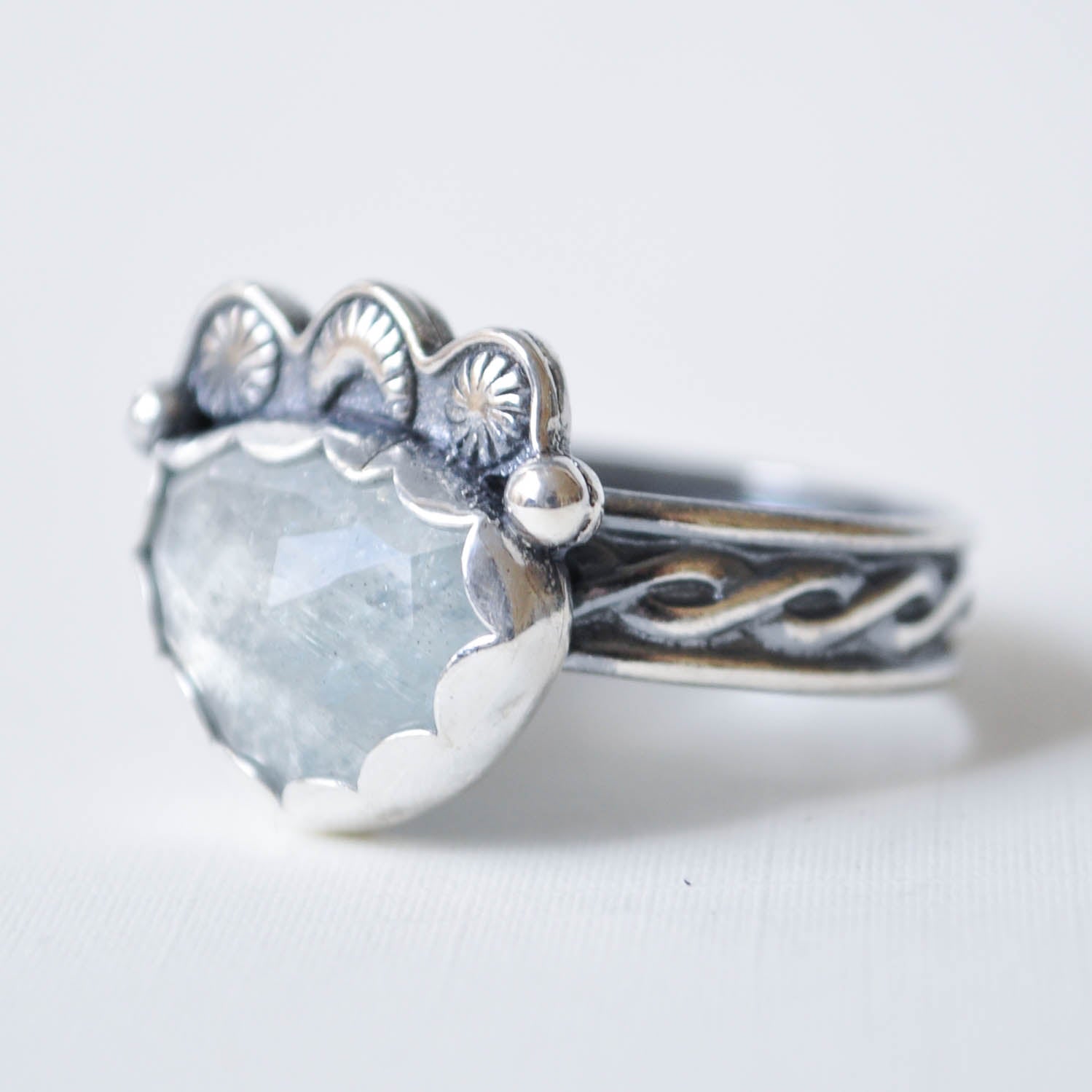 Silver ring with a large gemstone on a white background