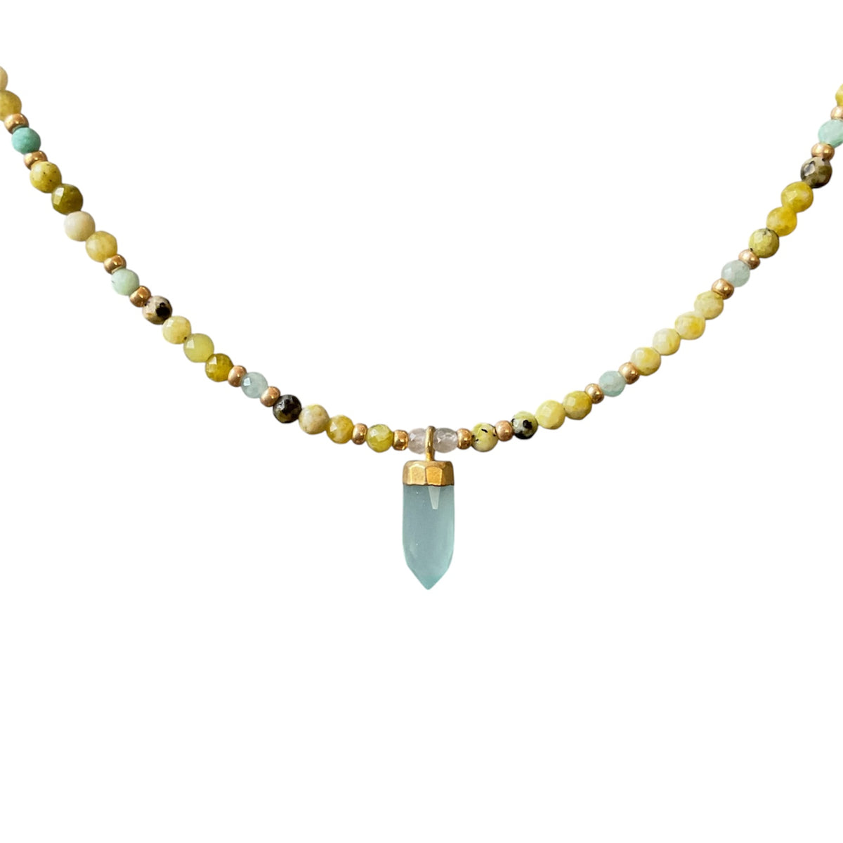 A beaded necklace featuring a central light blue crystal point pendant, flanked by small gold spacer beads and a mix of yellow, green, and brown stones on a plain white background.