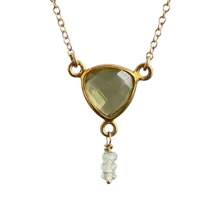 Necklace with a triangle-shaped green gemstone pendant on a white background