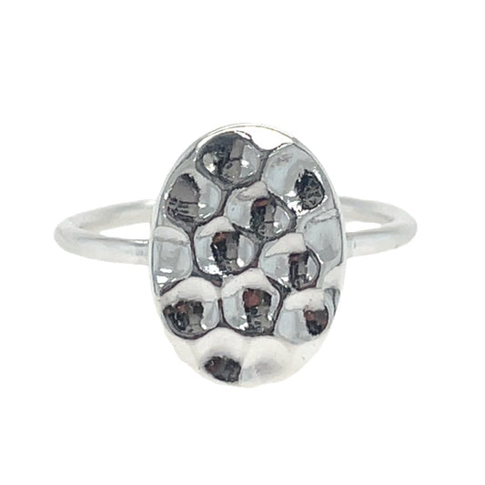 Silver ring with a textured oval design on a white background