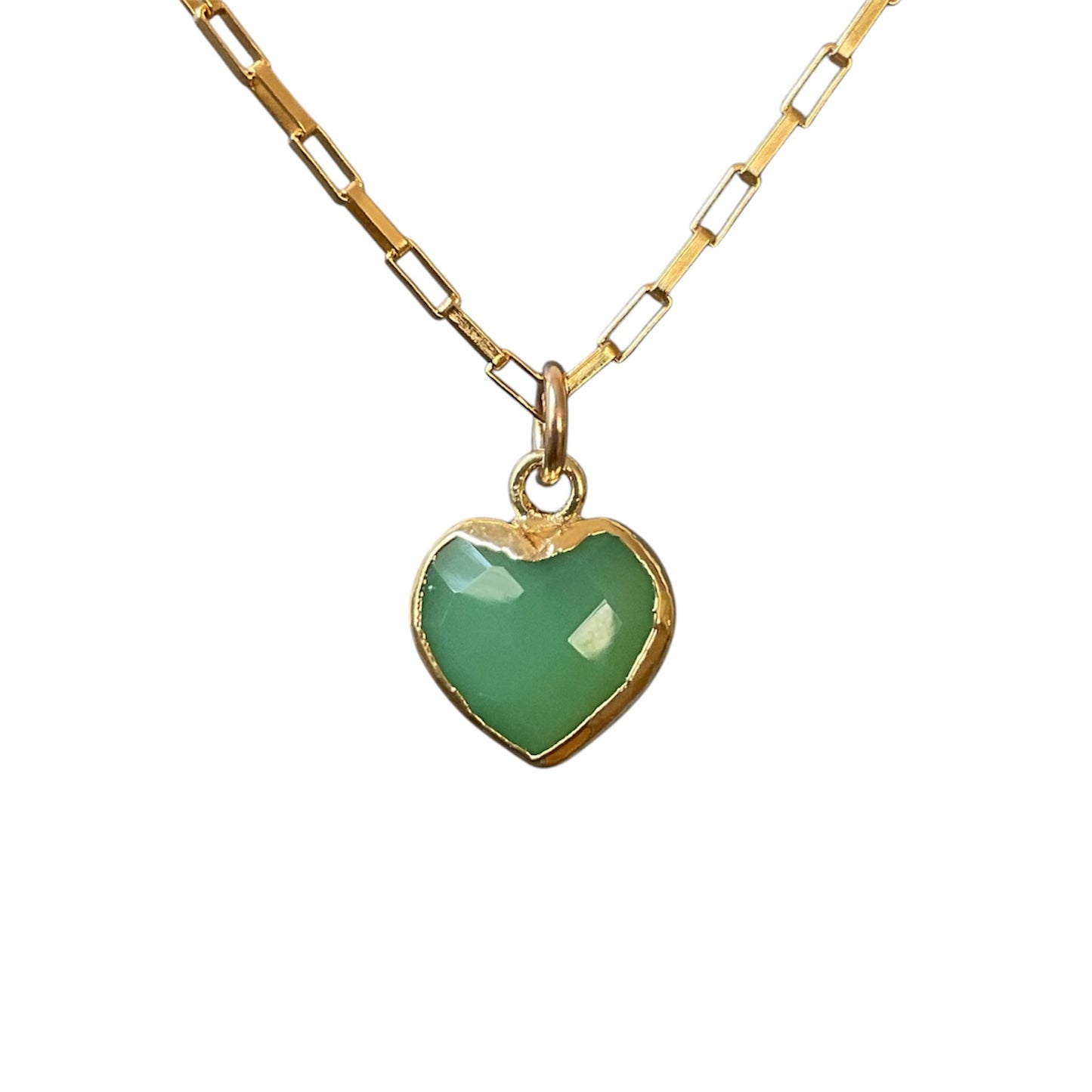 Gold necklace with a green heart pendant on a white background