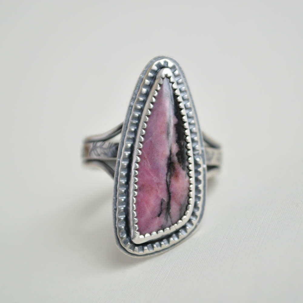 Sterling silver rhodonite gemstone ring with a textured border and split band