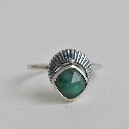 Emerald gemstone set with a crescent moon ring band.
