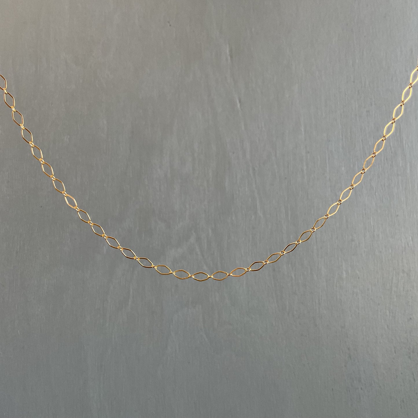 Gold chain on a gray background