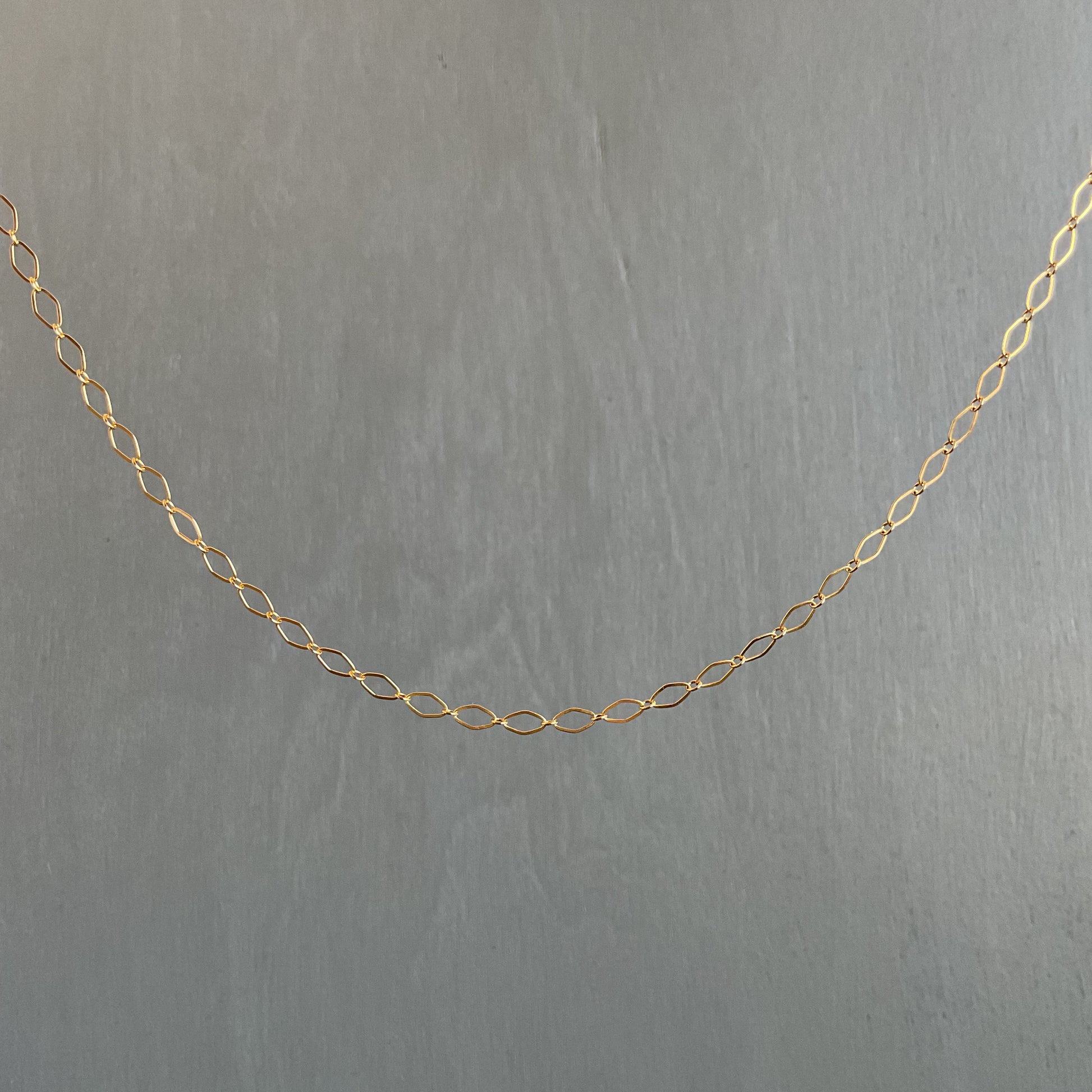 Gold chain on a gray background