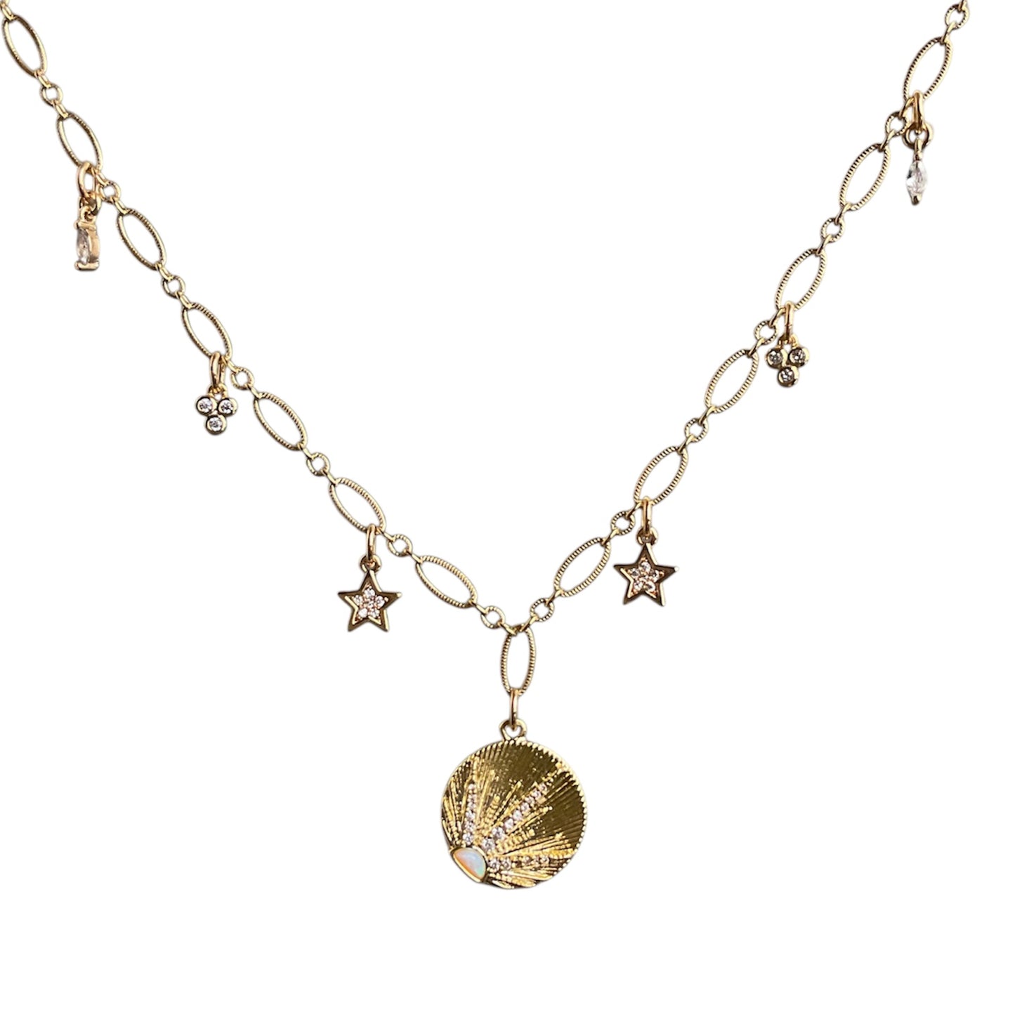 Gold necklace with sunburst pendant and star charms on a white background