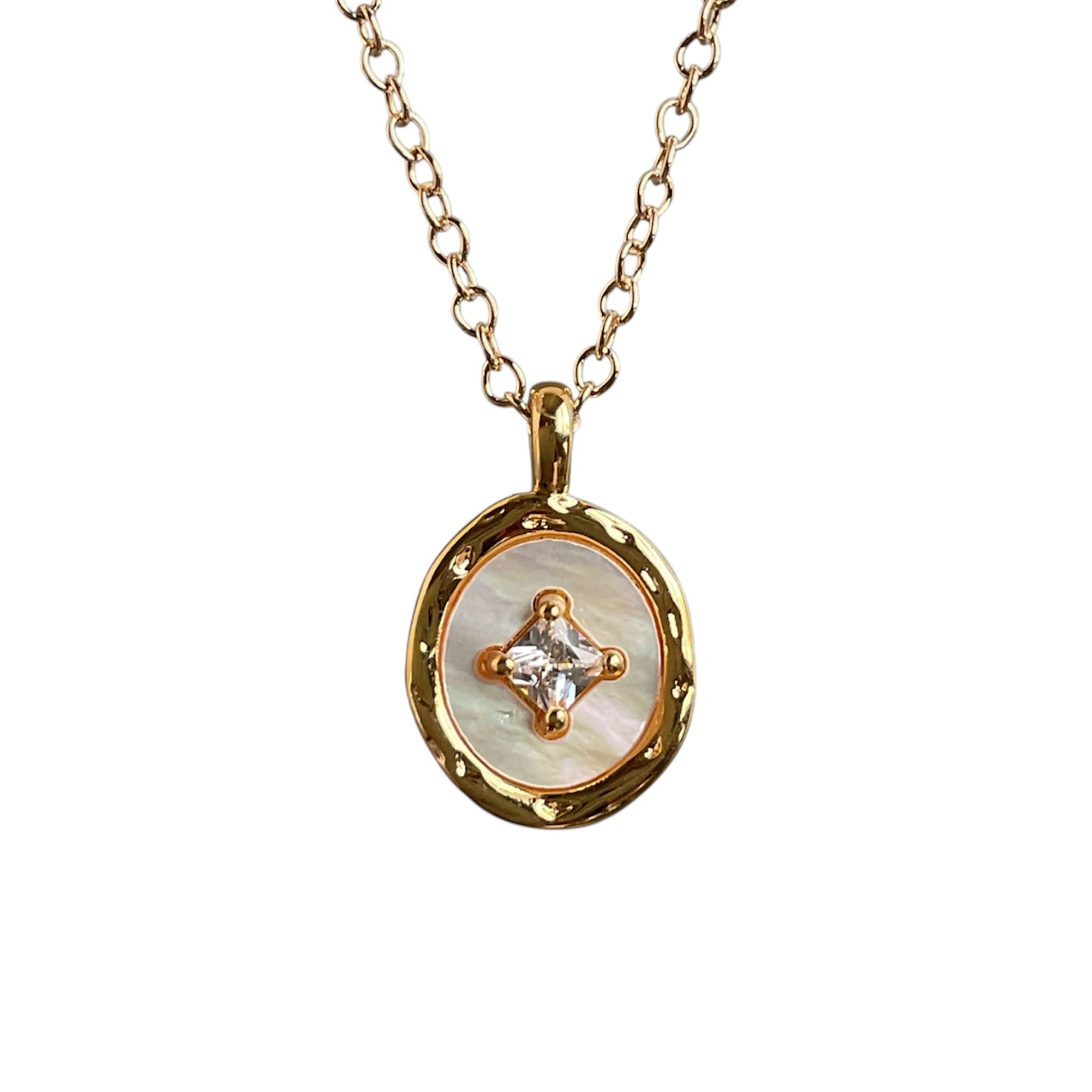 Gold necklace with a circular pendant featuring a diamond on a white background