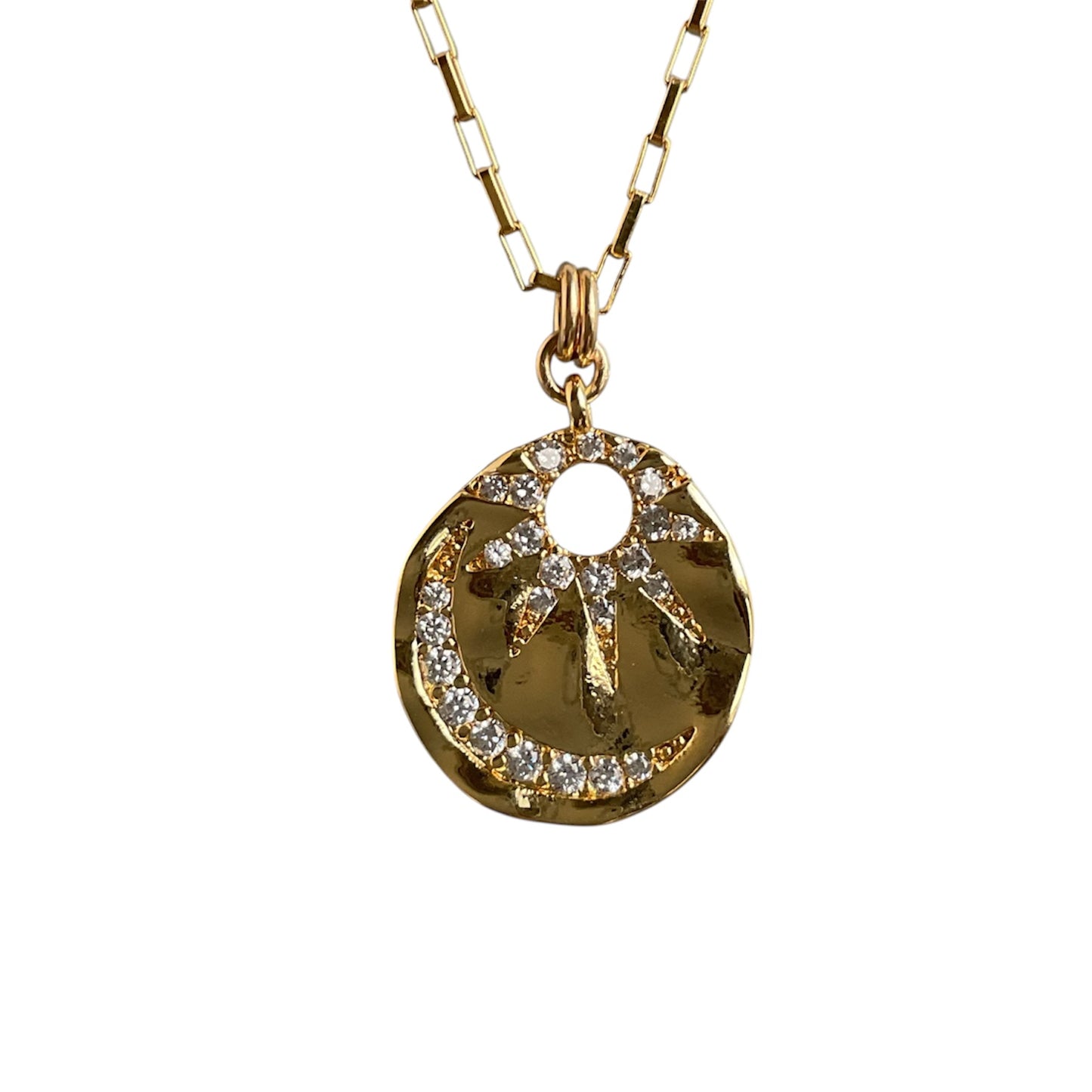 Gold necklace with a circular pendant on a white background