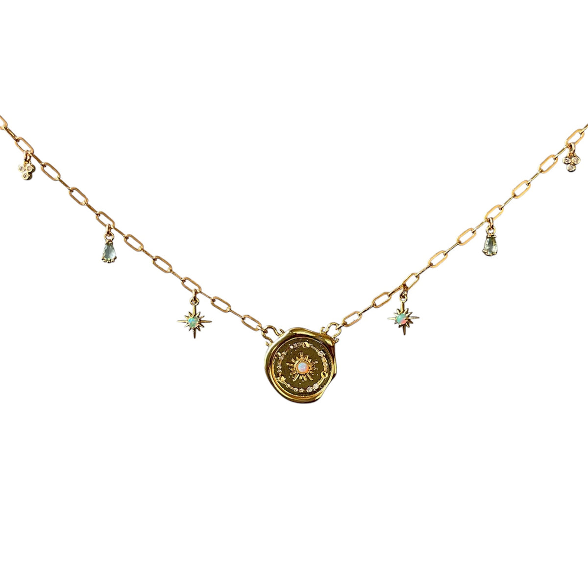A gold chain necklace featuring a central spiral pendant with a small pink gemstone and several dangling starburst charms with light blue and pink stones, set against a plain white background.