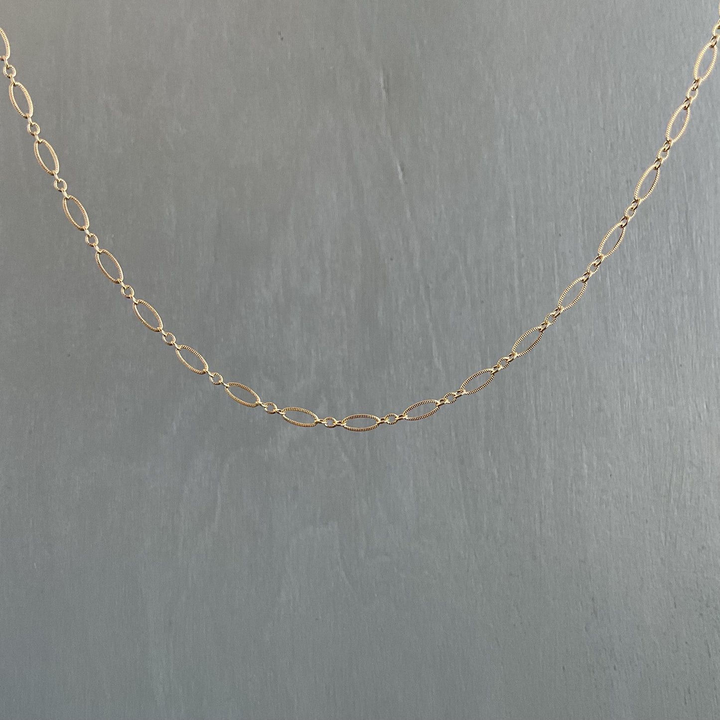 Gold chain on a gray background
