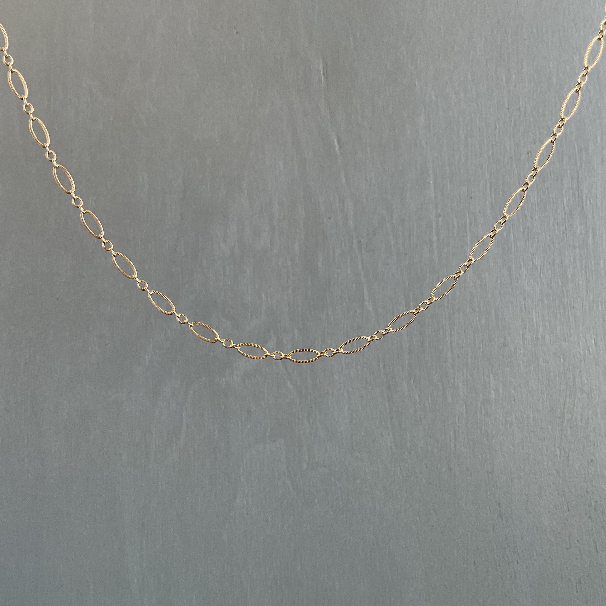 Gold chain on a gray background