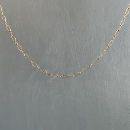 Gold chain on a gray background
