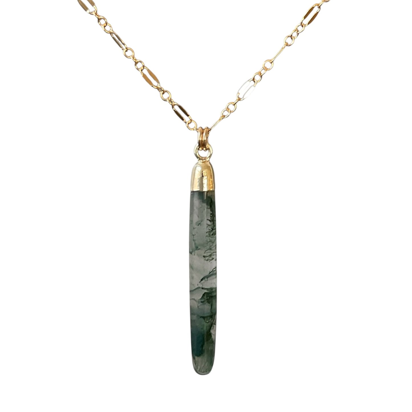 Necklace with a green marbled pendant on a gold chain against a white background