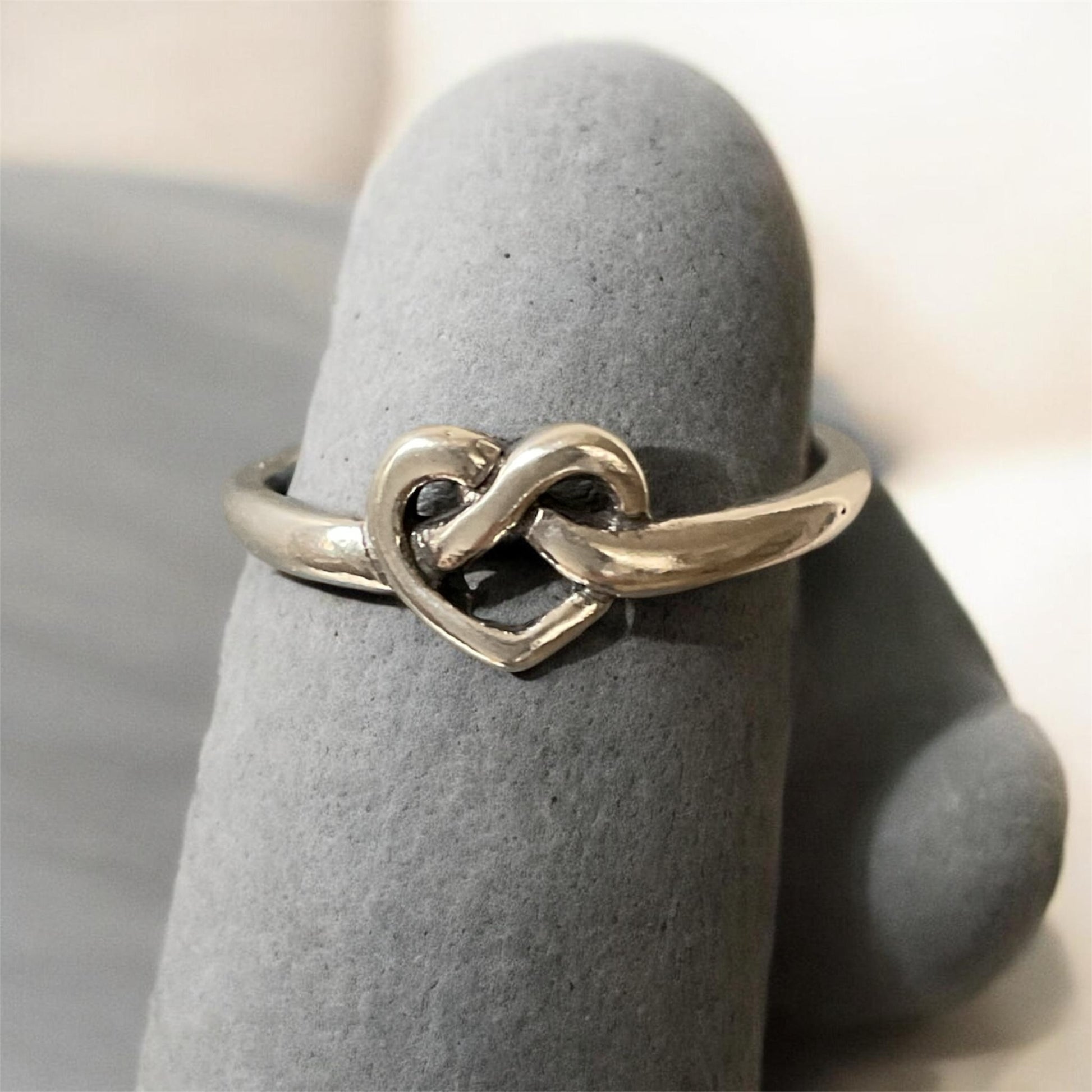 Sterling silver ring with a knot in the shape of a heart.