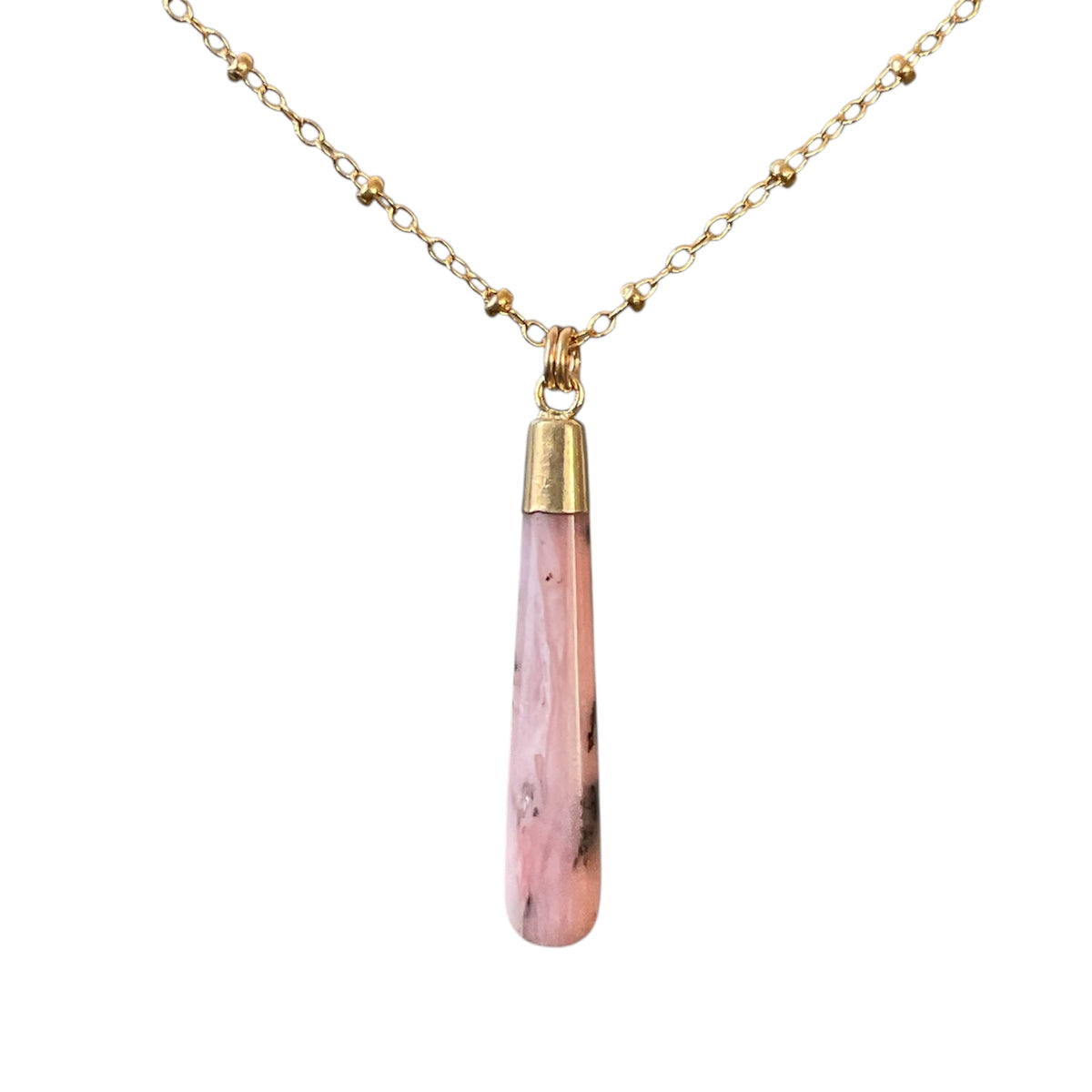 Necklace with a pink teardrop pendant on a gold chain against a white background