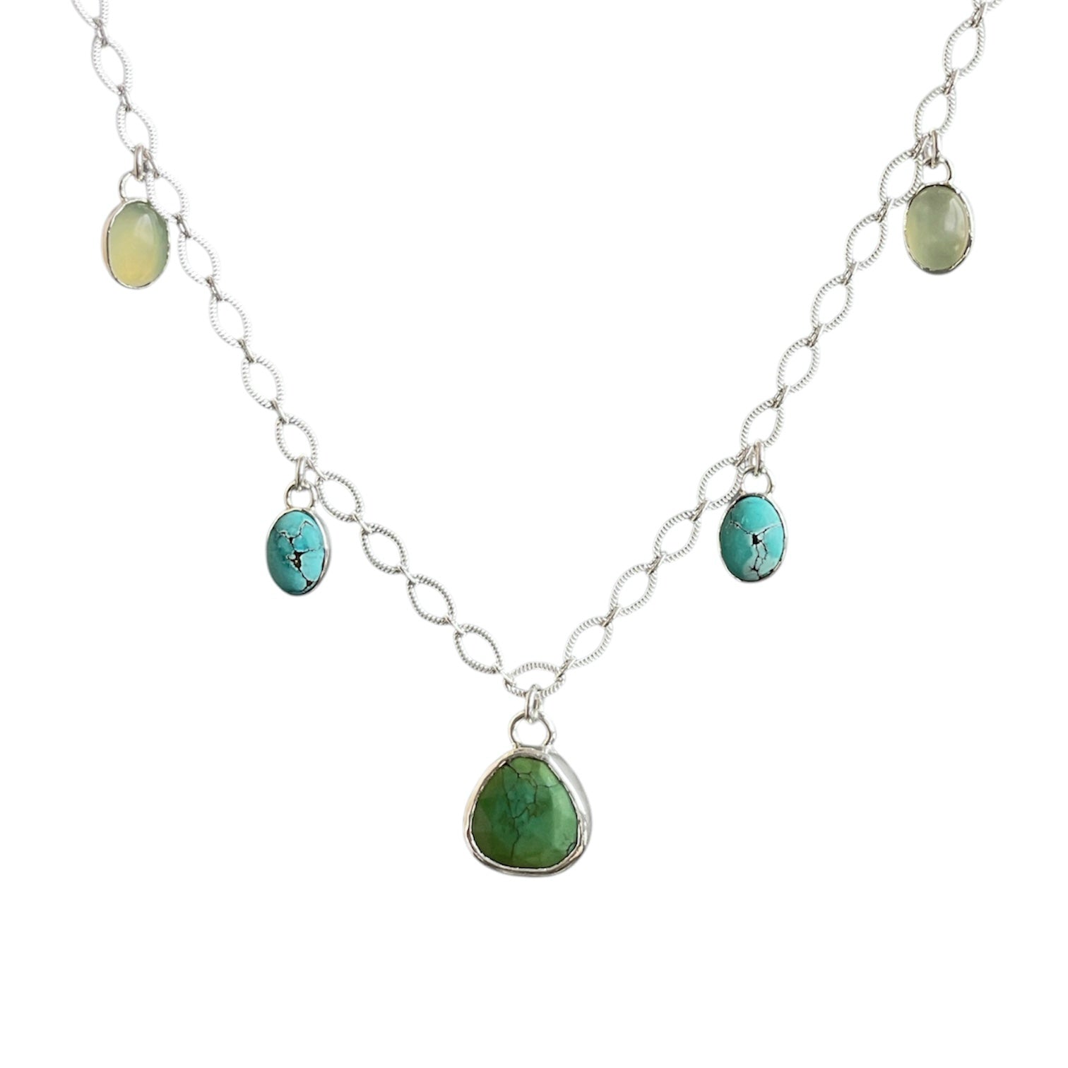 Green turquoise charm centered on a sterling silver oval lacey chain with blue turquoise and green jade gemstone charms.
