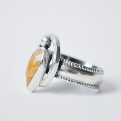 Silver ring with a stone on a white background