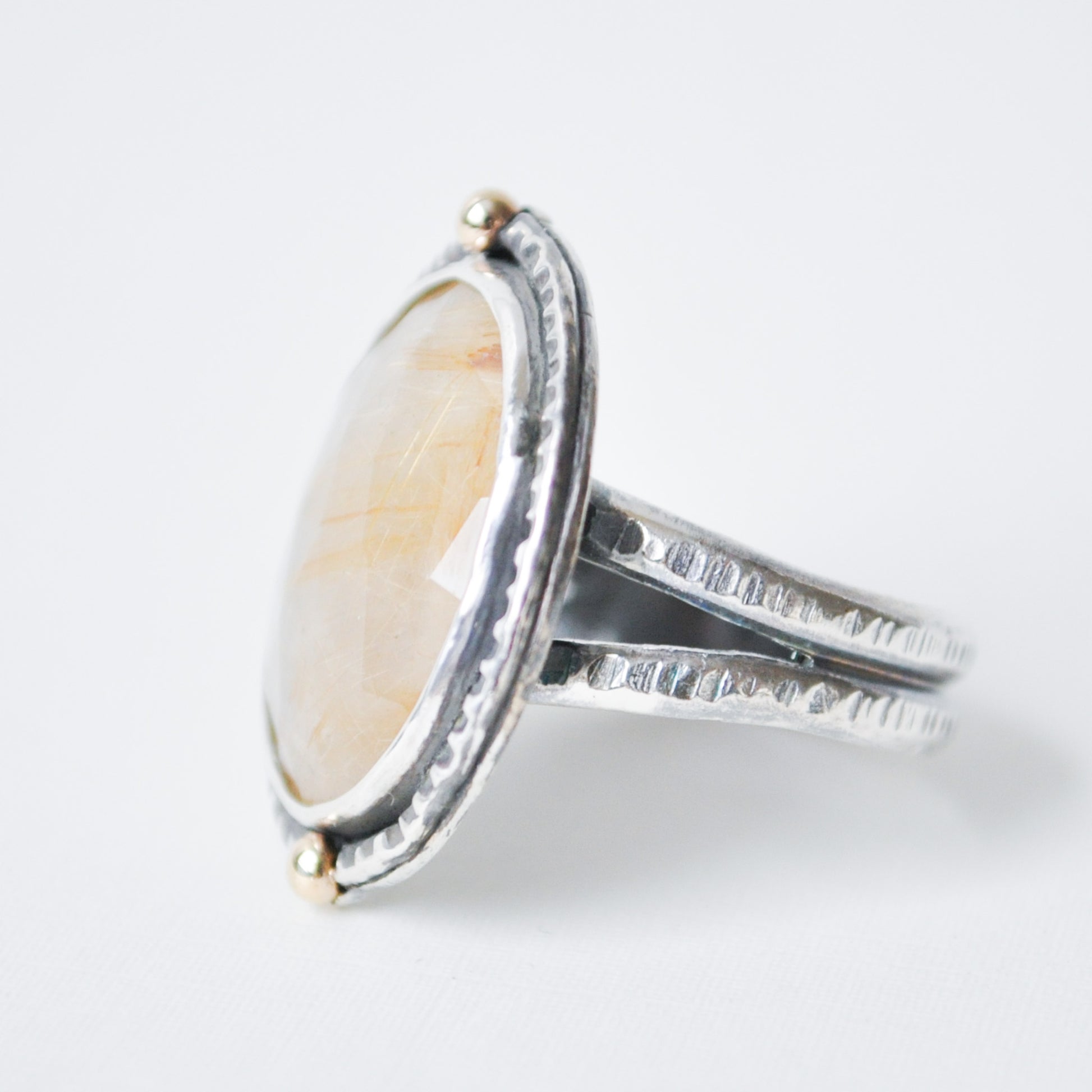 Silver ring with a large oval stone on a white background