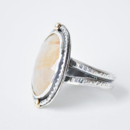 Silver ring with a large oval stone on a white background