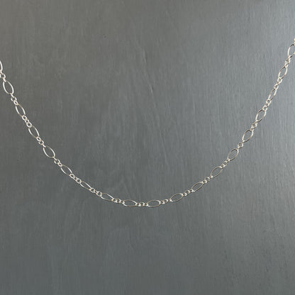 Silver chain on a dark gray background