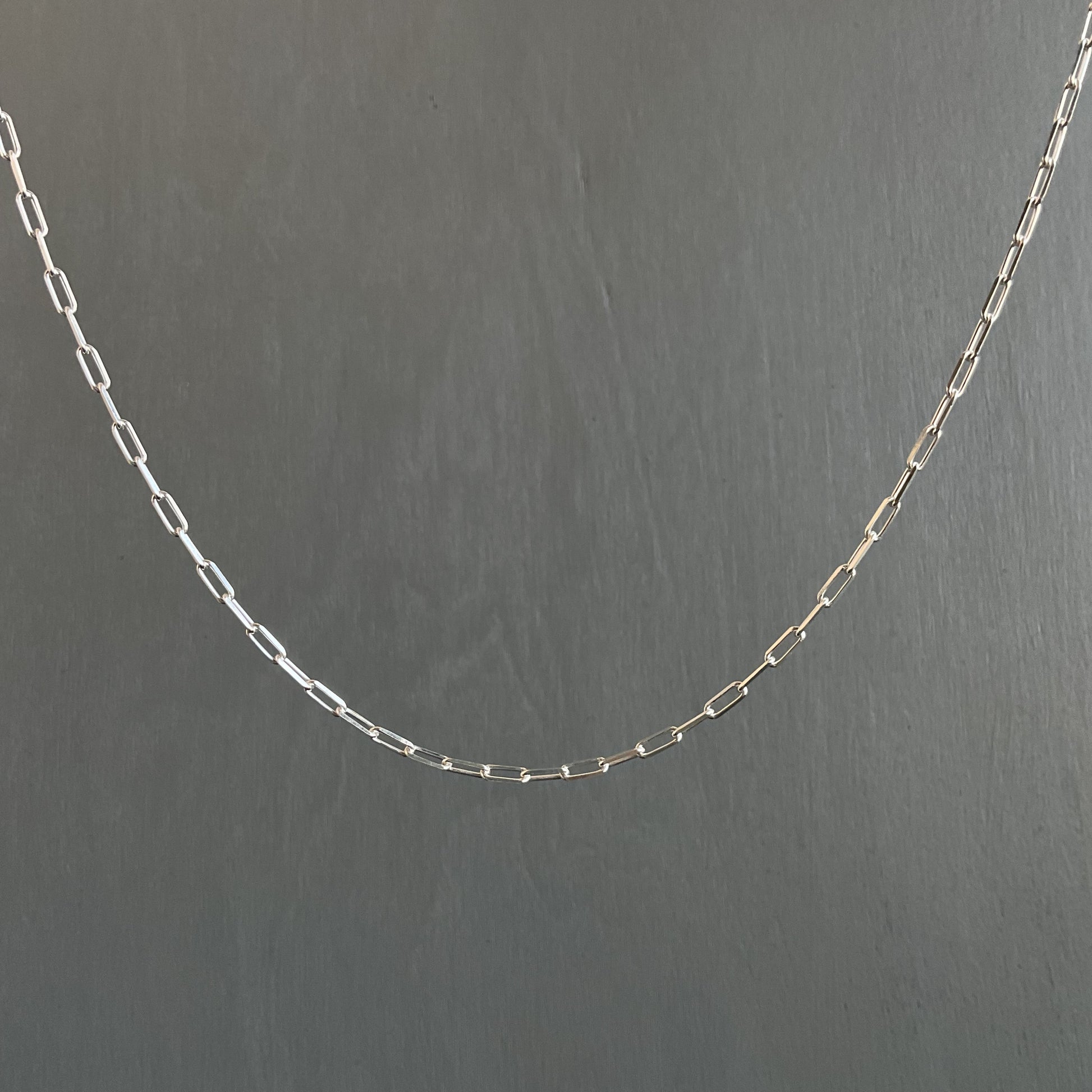 Silver chain on a dark gray background