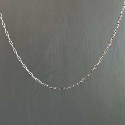Silver chain on a dark gray background