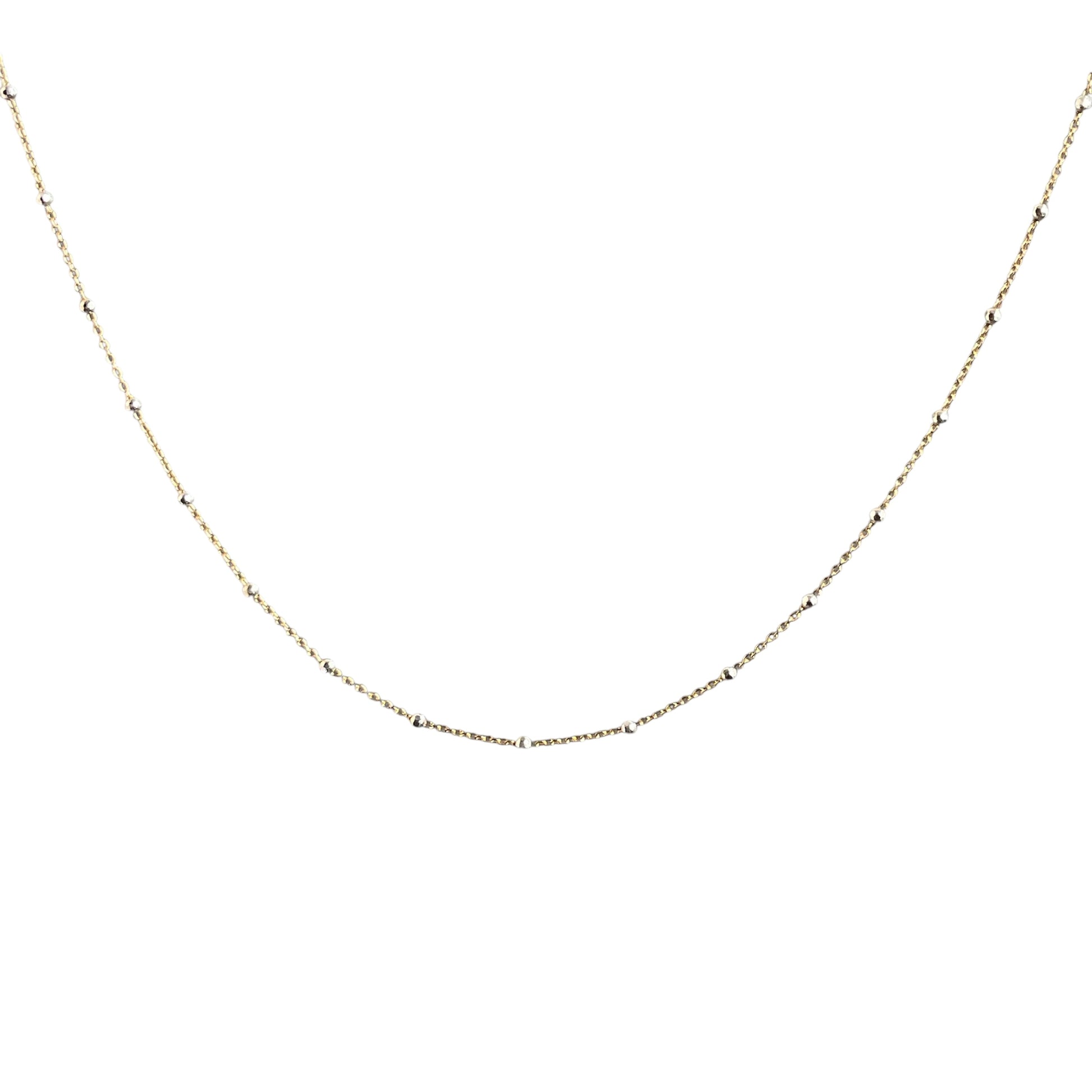 Gold chain necklace on a white background